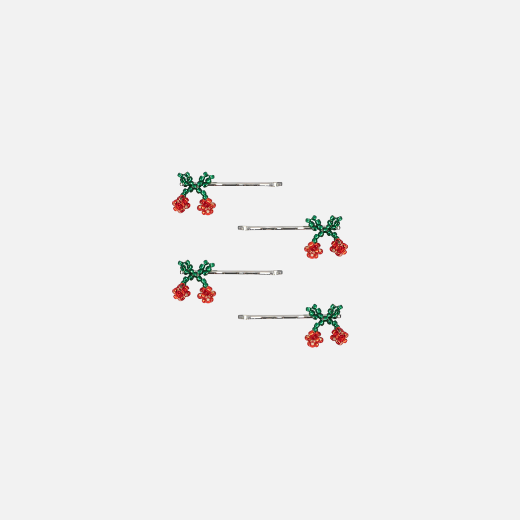 Set of hair pins with green leaves and red berries on a white background