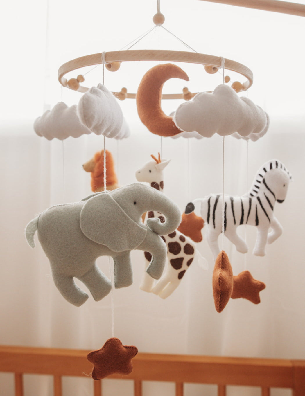 baby mobile with safari animals including an elephant, giraffe, zebra and lion